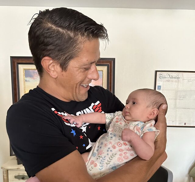Cody Snyder holding a baby.